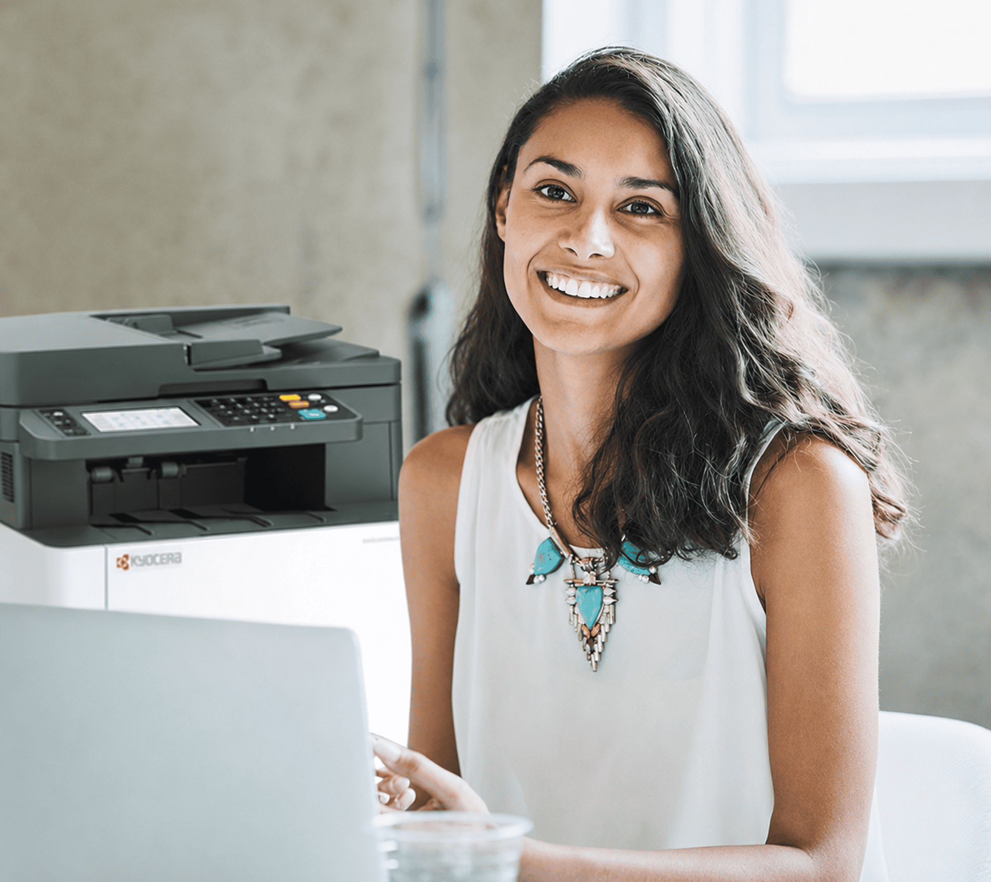 Woman at desk with Kyocera multifunction printer